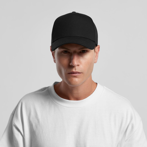 A black cap with a structured design and a logo, worn by a model in a white t-shirt.