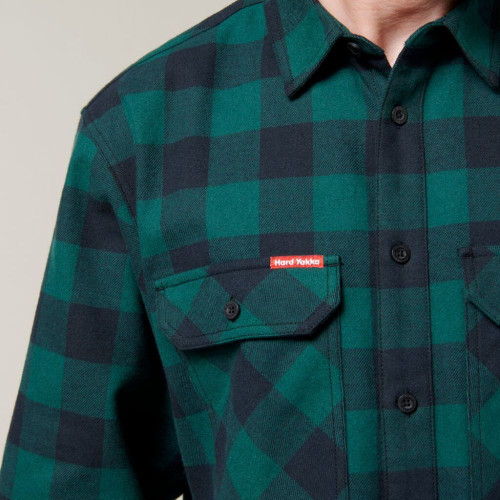 Detail of green checkered flannel shirt.