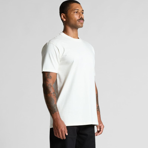 A model wearing a plain white organic T-shirt, featuring short sleeves and a relaxed fit. A model wearing a plain white organic T-shirt, featuring short sleeves and a relaxed fit.