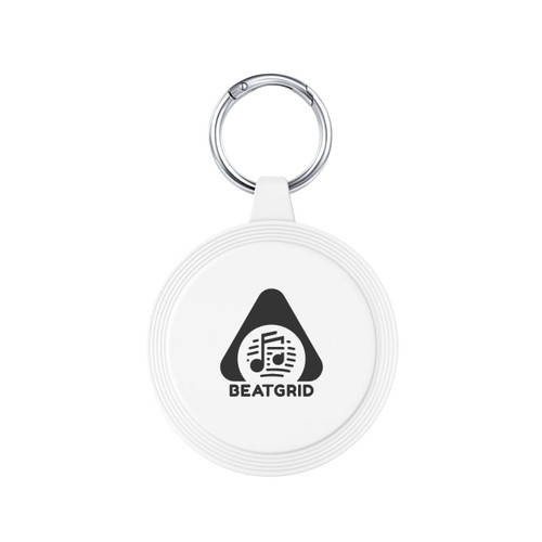 A white keychain with a circular design and a silver keyring, featuring a logo with musical notes.