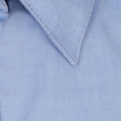 A light blue button-up shirt featuring a classic collar and a minor branding element.