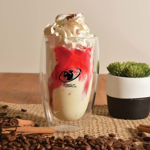 A double wall glass cup featuring a logo, filled with a dessert topped with whipped cream and strawberry sauce.