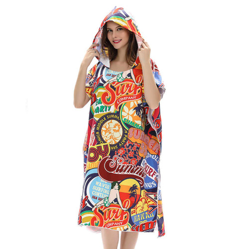 A vibrant poncho towel with a hood, featuring a collage of colourful beach-themed designs and logos.
