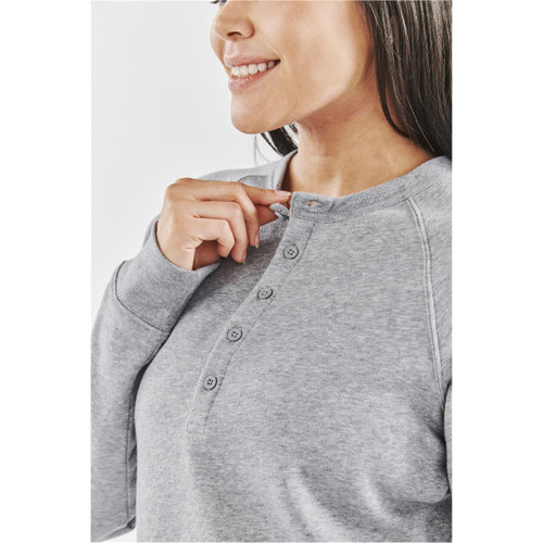 A grey women's henley shirt with a button placket, featuring a relaxed fit and a soft fabric texture.