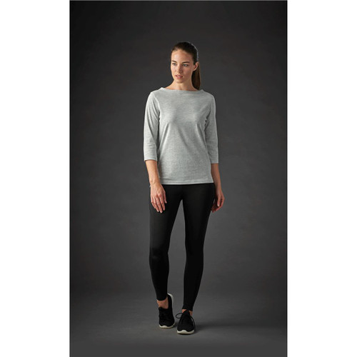 A grey women's 3/4 sleeve tee paired with black leggings, featuring a subtle logo.