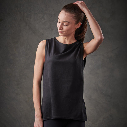 A woman wearing a black tank top with a sleek design, featuring an unobtrusive logo.