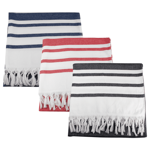 Three Trekk Turkish beach towels in navy blue, red, and charcoal grey, each with white stripes and fringed edges. Three Trekk Turkish beach towels in navy blue, red, and charcoal grey, each with white stripes and fringed edges.