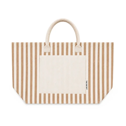 Front view of a beige and natural striped Hampton tote bag with sturdy handles, a spacious silhouette, and a contrast front pocket.