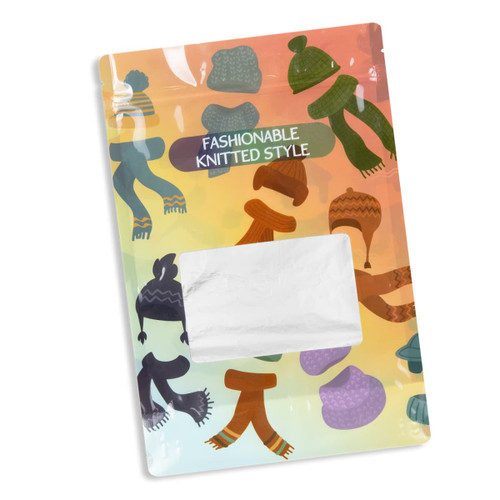 A large foil stand-up pouch featuring a colourful design of knitted hats and scarves. It has a transparent window and a logo.