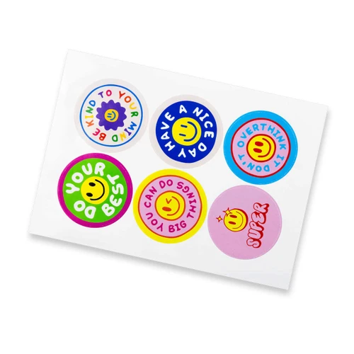 A sheet of six glossy stickers featuring colourful circle designs with smiley faces and motivational phrases.