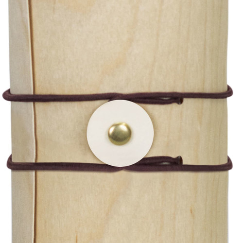 A drink bottle with a natural wood appearance, secured by dark brown straps and a circular fastening.