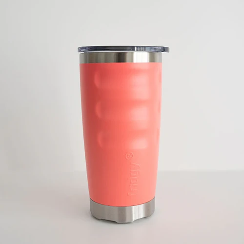 Front view of a coral pink fridgy® 600ml insulated tumbler featuring ergonomic grip contours, embossed branding, a stainless steel base, and a clear push-on lid.
