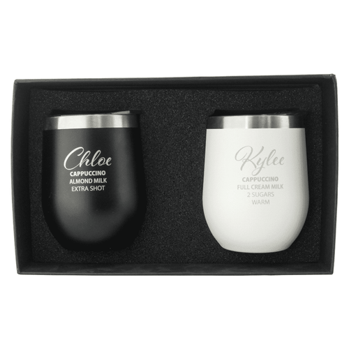 An insulated cup gift set featuring a black cup and a white cup, both with a sleek design and metallic lids. An insulated cup gift set featuring a black cup and a white cup, both with a sleek design and metallic lids.