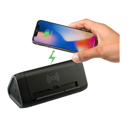 A black power bank with wireless charging feature, paired with a smartphone displaying a charging indicator.