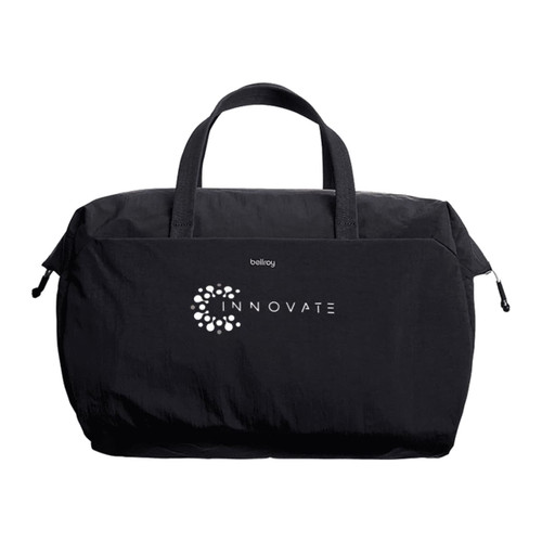 A black duffel bag with short handles and a branding logo on the front. A black duffel bag with short handles and a branding logo on the front.