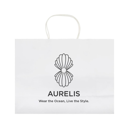 A large white paper bag with a decorative logo design and handles. Features minimalistic branding and text.