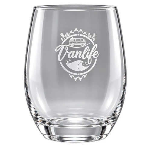 A clear stemless wine glass featuring an etched design related to "Vanlife" and outdoor themes.