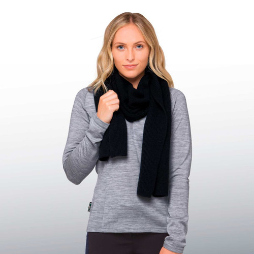 A woman wearing a black 100% Merino scarf, paired with a grey long-sleeve top, model poses with a relaxed look. A woman wearing a black 100% Merino scarf, paired with a grey long-sleeve top, model poses with a relaxed look.