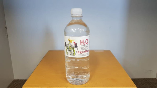 A drink bottle filled with clear water, featuring a label with graphics and a logo, on a brown surface. A drink bottle filled with clear water, featuring a label with graphics and a logo, on a brown surface.