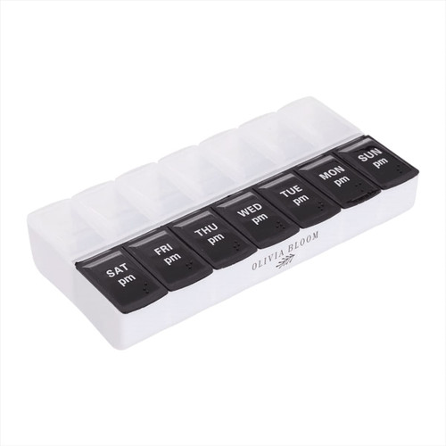 A white and black AM/PM pill case with compartments for each day of the week. Features a logo on the base. A white and black AM/PM pill case with compartments for each day of the week. Features a logo on the base.