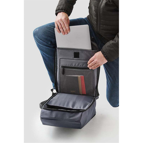A grey backpack with a laptop compartment and additional pockets, being held by a person in casual attire.