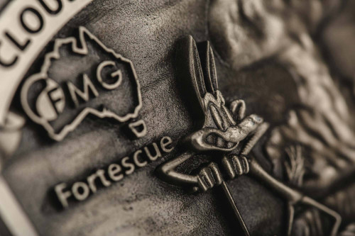 Close-up of a Fortescue metal coin featuring FMG logo and cartoon character.