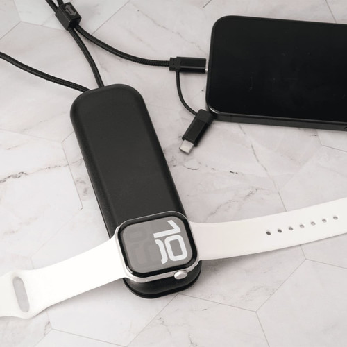 A foldable black charging cable with multiple connectors and a white wireless watch charger on a marble surface. A foldable black charging cable with multiple connectors and a white wireless watch charger on a marble surface.