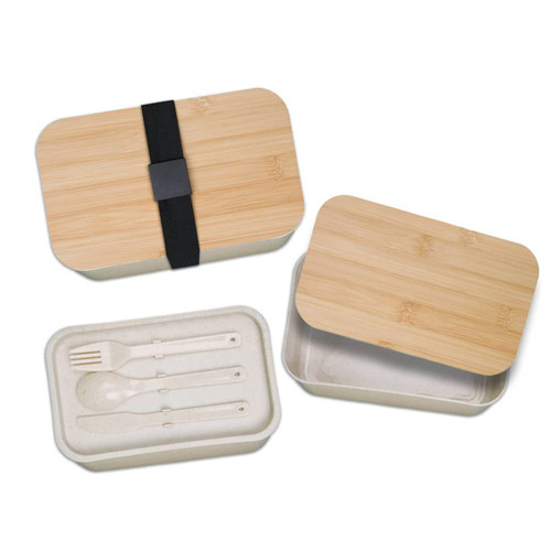 A bamboo-lid lunch box in natural tones, featuring a removable tray with utensils and a black elastic strap. A bamboo-lid lunch box in natural tones, featuring a removable tray with utensils and a black elastic strap.