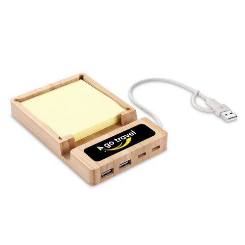 A bamboo USB hub with sticky note holder, featuring multiple USB ports and a connecting cable. It has a logo on the front. A bamboo USB hub with sticky note holder, featuring multiple USB ports and a connecting cable. It has a logo on the front.