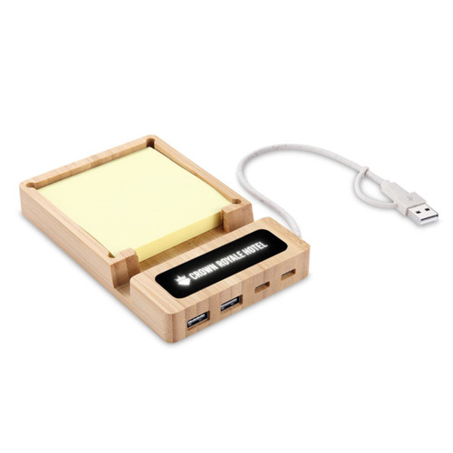 A USB hub and sticky note holder made of bamboo, featuring multiple USB ports and a connected power cable. A USB hub and sticky note holder made of bamboo, featuring multiple USB ports and a connected power cable.