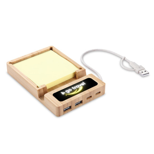 A USB hub with a wooden base featuring sticky note pads, multiple USB ports, and a digital display. A USB hub with a wooden base featuring sticky note pads, multiple USB ports, and a digital display.