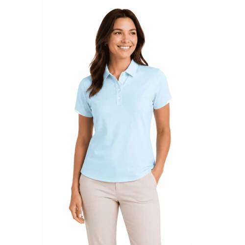 A woman wearing a light blue polo shirt with a collar and buttons, paired with cream-coloured pants.