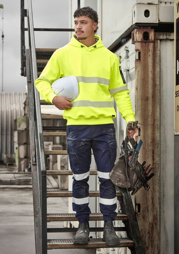 A bright yellow water-resistant hoodie with segmented reflective tape, worn with navy work pants and safety gear. A bright yellow water-resistant hoodie with segmented reflective tape, worn with navy work pants and safety gear.