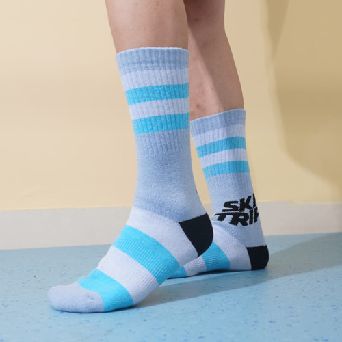 Merino wool socks in light blue and grey with stripes, featuring a logo on the heel. Merino wool socks in light blue and grey with stripes, featuring a logo on the heel.