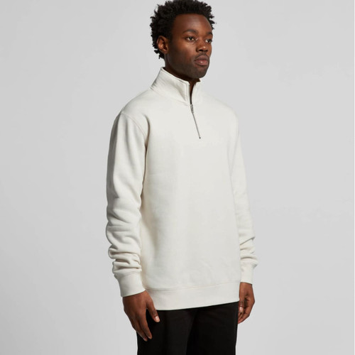 A cream-coloured half zip crew jumper designed for comfort, featuring a stand-up collar and long sleeves.
