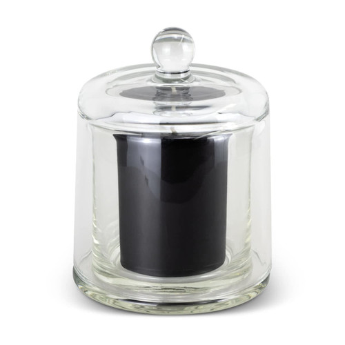A glass cloche with a clear lid encasing a black candle, featuring a rounded top and smooth base. A glass cloche with a clear lid encasing a black candle, featuring a rounded top and smooth base.
