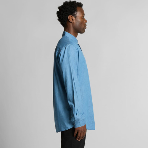 A blue denim button-up shirt displayed on a model from the side, featuring long sleeves and a collar. A blue denim button-up shirt displayed on a model from the side, featuring long sleeves and a collar.