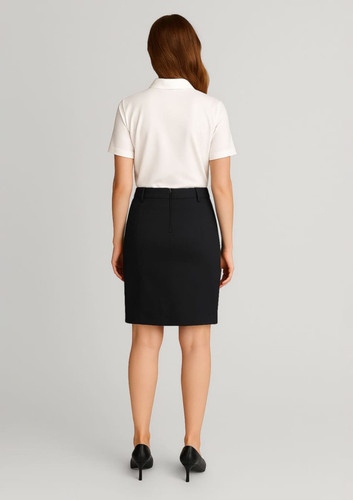 A black women's mid waist stretch chino skirt displayed on a model from the back, paired with a white polo shirt. A black women's mid waist stretch chino skirt displayed on a model from the back, paired with a white polo shirt.