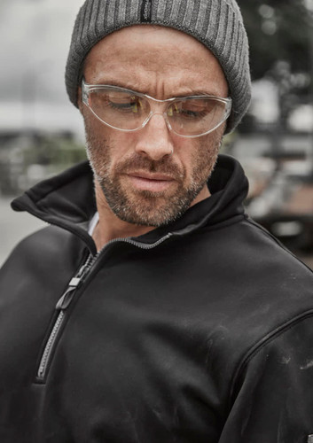 A black water-resistant pullover featuring a 1/4 zip and a collar, worn by a man with glasses and a grey beanie. A black water-resistant pullover featuring a 1/4 zip and a collar, worn by a man with glasses and a grey beanie.