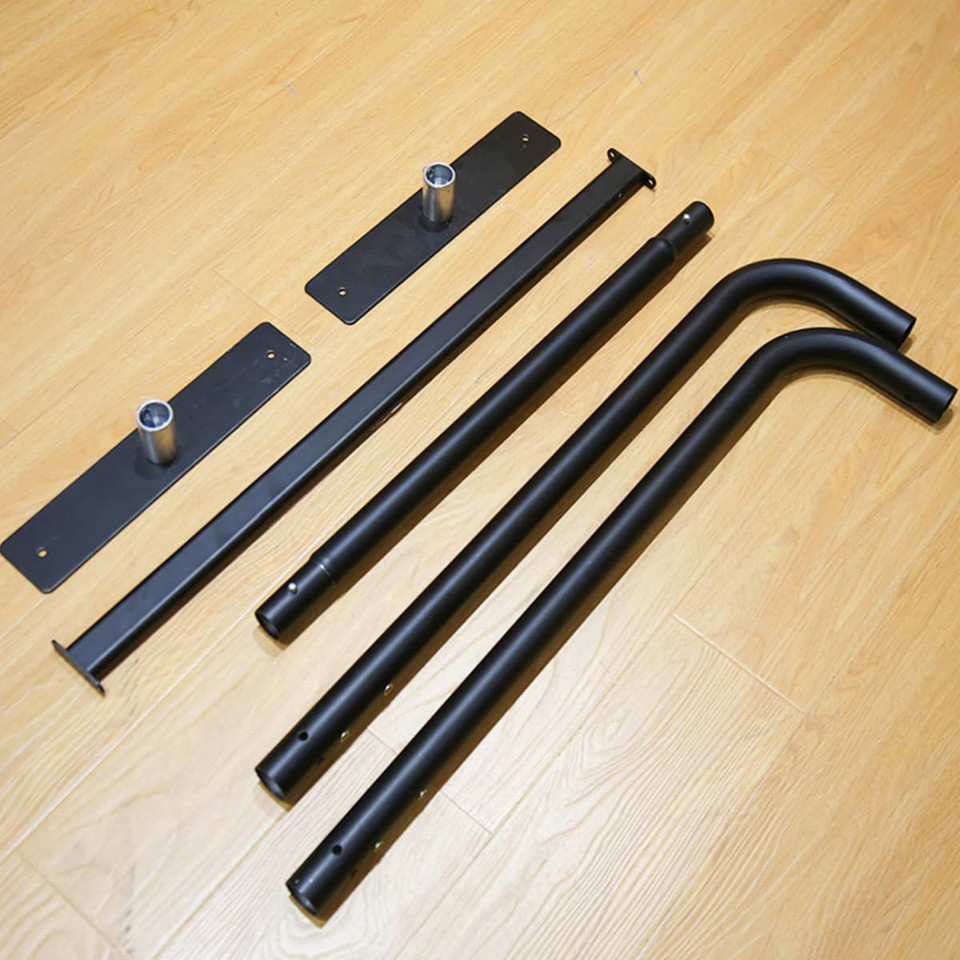 A collection of black metal components including straight and curved bars, and base plates for assembly.