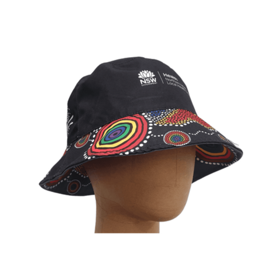 A black reversible bucket hat featuring a colourful Indigenous-inspired pattern, with a logo on the front.