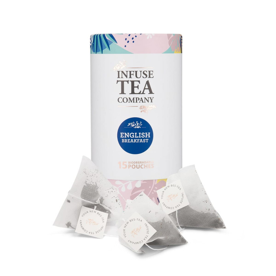 A tea canister with a floral design, featuring English Breakfast tea pouches in white biodegradable bags.