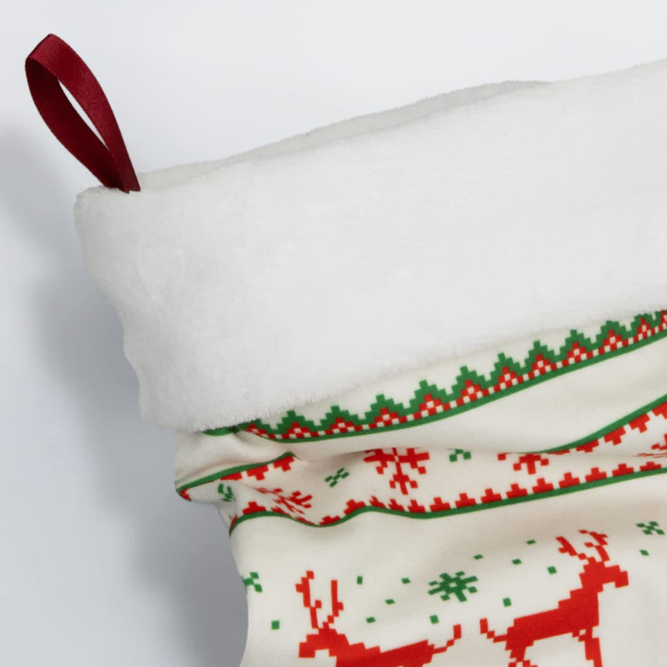 A festive Christmas stocking in white, red, and green, featuring a soft top and decorative patterns.