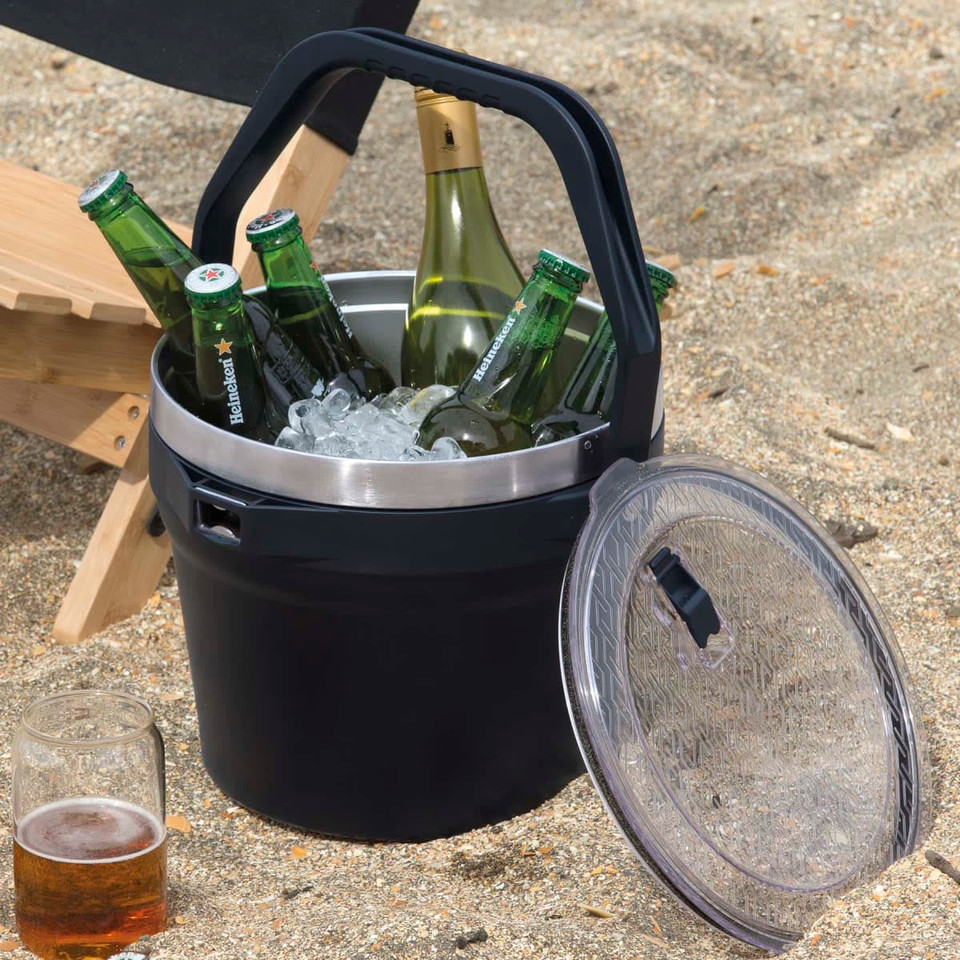 A black 7.2L bucket with a stainless steel interior, filled with ice and bottles, accompanied by a glass of beer.