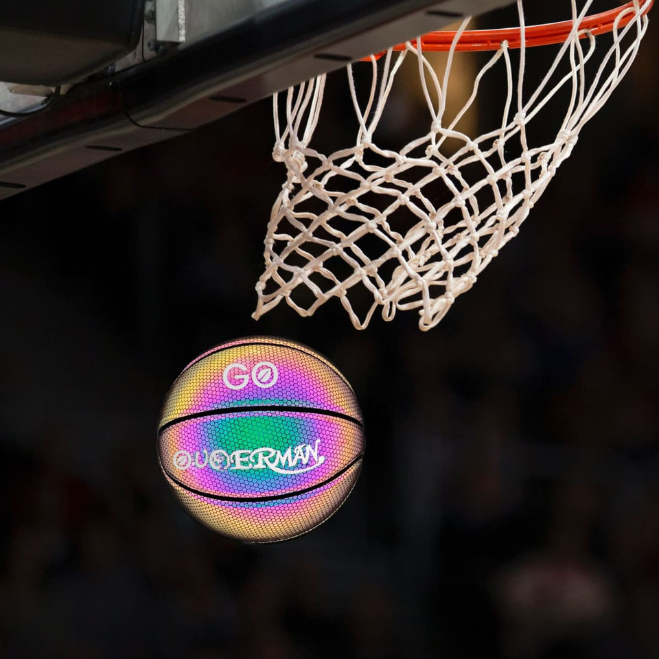 A holographic glowing basketball in a rainbow of colours, poised to go through a basketball hoop.