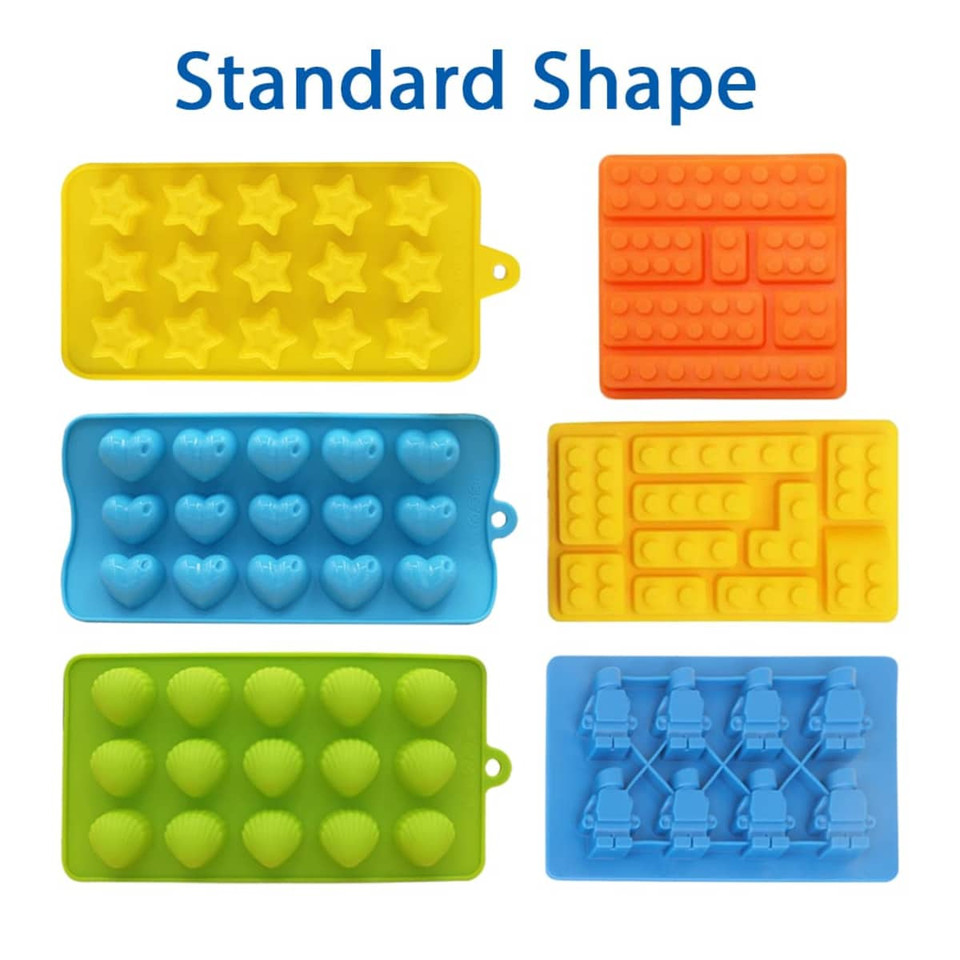 Custom shaped moulded ice cube trays in vibrant colours: yellow stars, blue hearts, green shells, orange and blue brick designs.