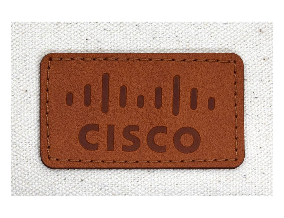 A brown leather label featuring the word "CISCO" on a light beige fabric background.