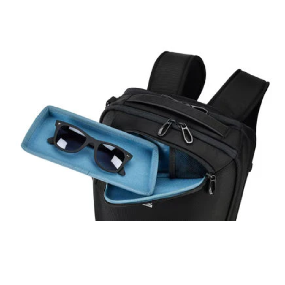 Black backpack with sunglasses in blue storage compartment.