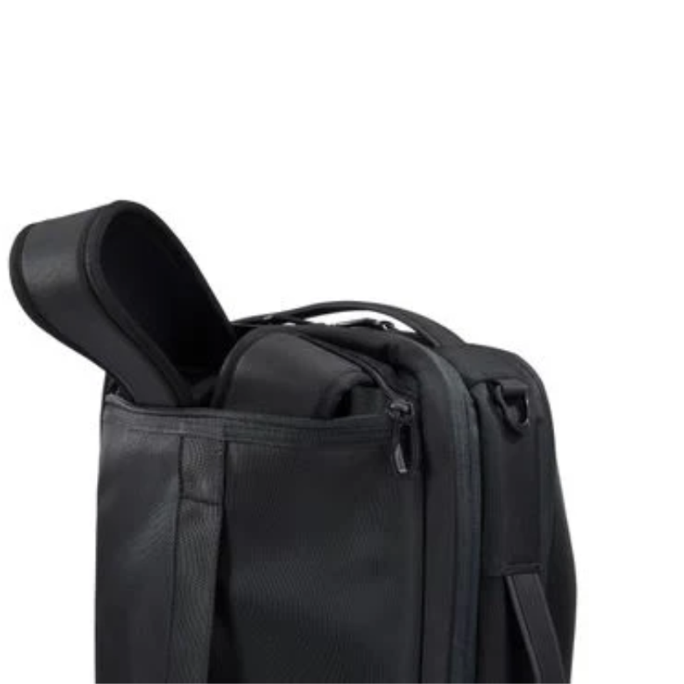 Black carry-on luggage with an open zip pocket.