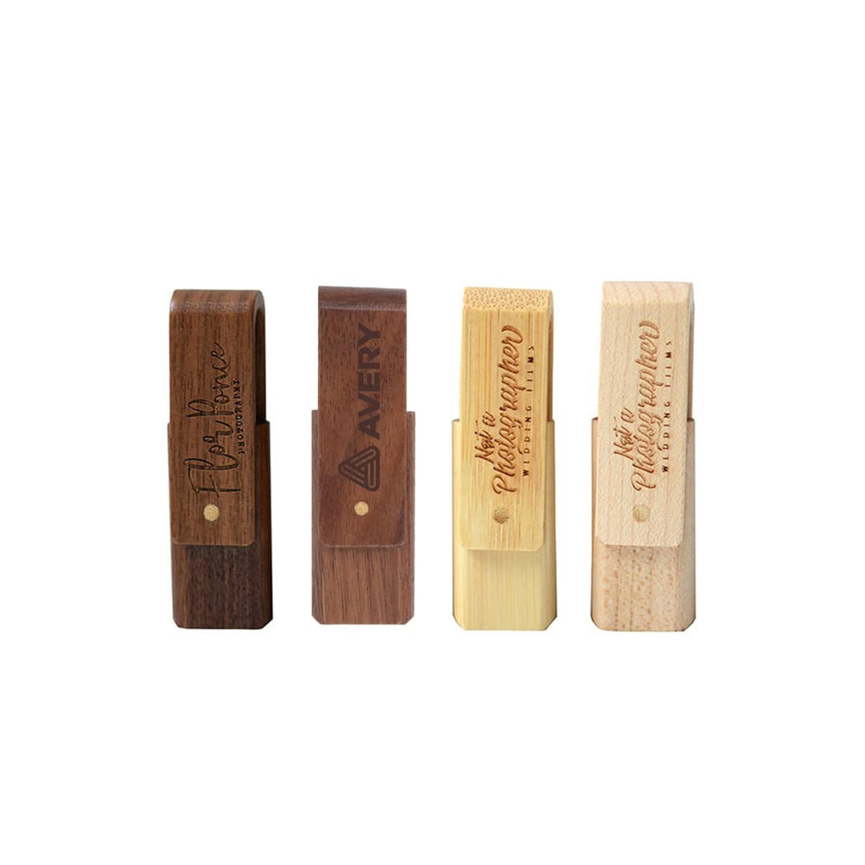 A collection of four wooden flash drives in various finishes, featuring different textures and engraved logos.